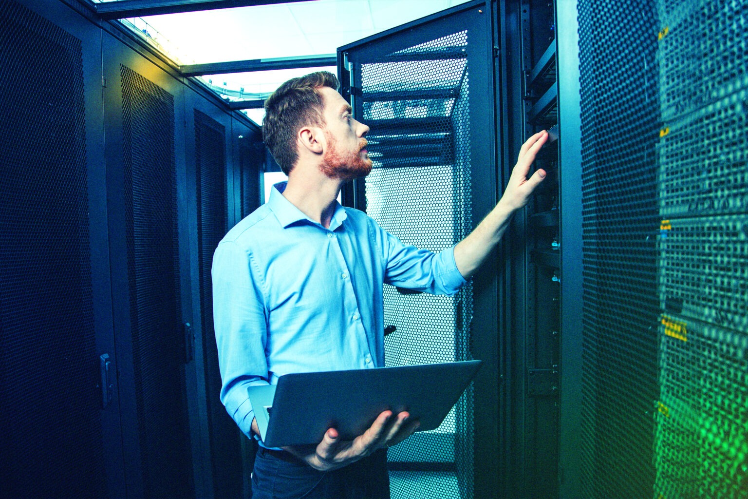 IT technician performing server diagnostics in data center