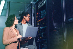 IT professionals reviewing server infrastructure in data center